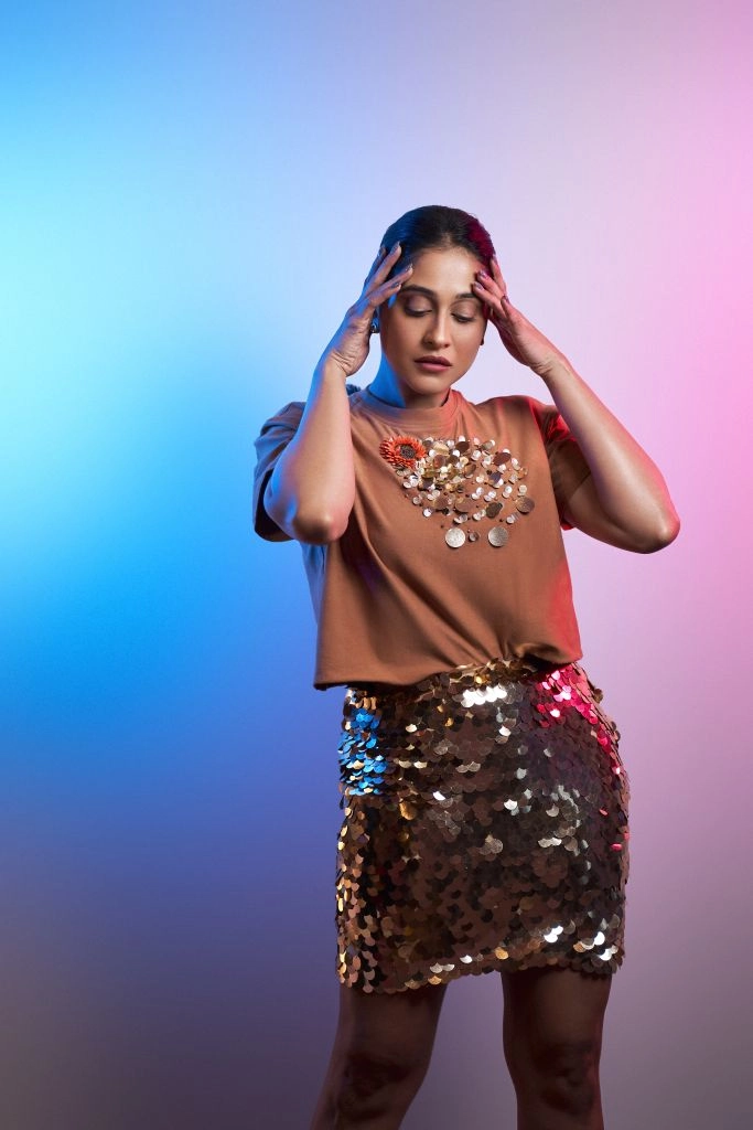 Regina Cassandra in Nirmooha's Crop T-Shirt with Sunflower Motif and Golden Sequin Short Skirt from the Ancienne Collection